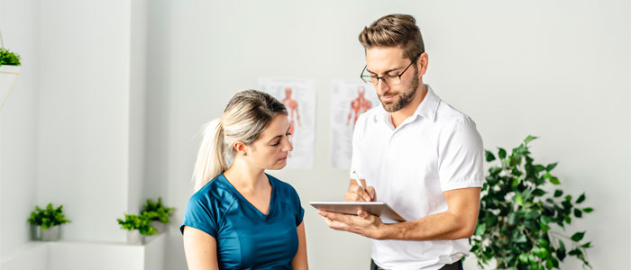 chiropractor discussing wellness plan with patient